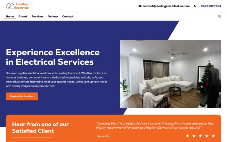 Modern living room with Christmas tree and white couch.