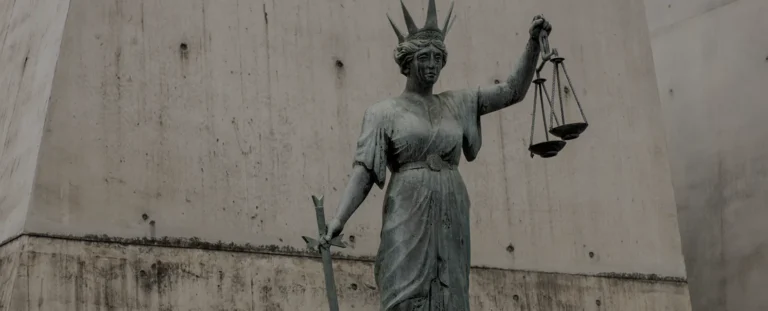 Statue of Lady Justice with scales and sword.