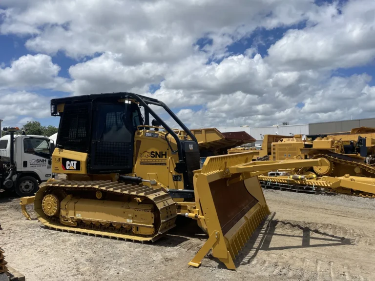 Yellow bulldozer parked on construction site.