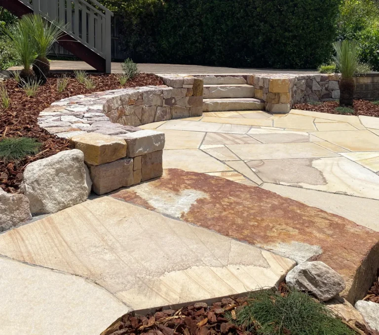 Stone patio with layered steps and greenery