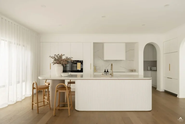 Modern white kitchen with island and stools
