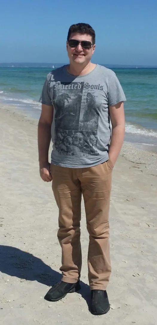 Person standing on sunny beach
